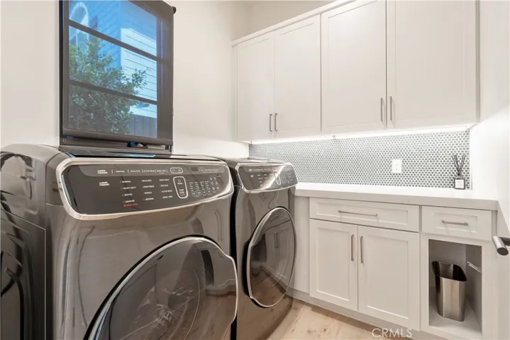 Large separate laundry room with ample storage.