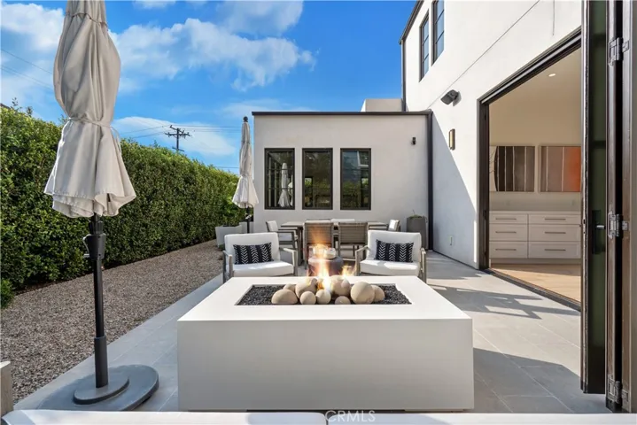 Relax by the fire feature in the backyard.