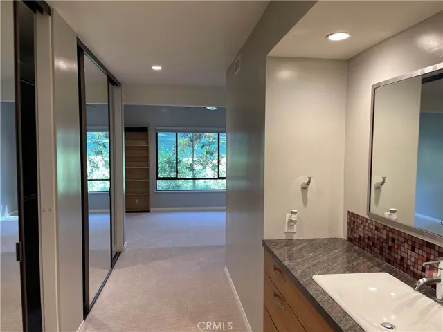 Master bedroom has dual mirror closets with custom shelves and organaizer.