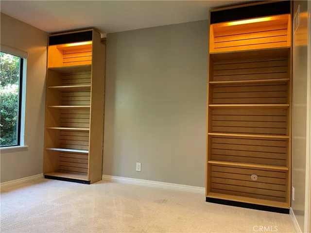 Second bedroom has custom built in shelves