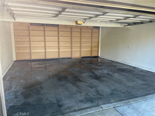 Very roomy garage with custom shelves.