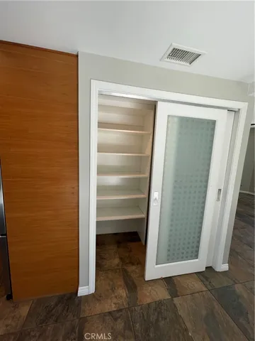 Laundry room has custom shelves.