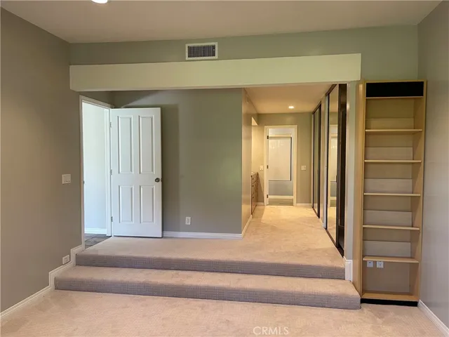 sunk in master bedroom with custom paint and upgraded carpet and built in shelves.
