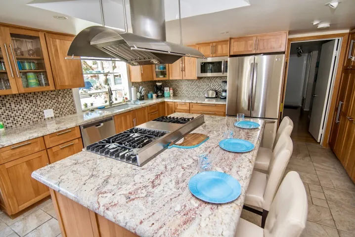 Kitchen with doorway into main level bedroom w/ensuite bathroom.