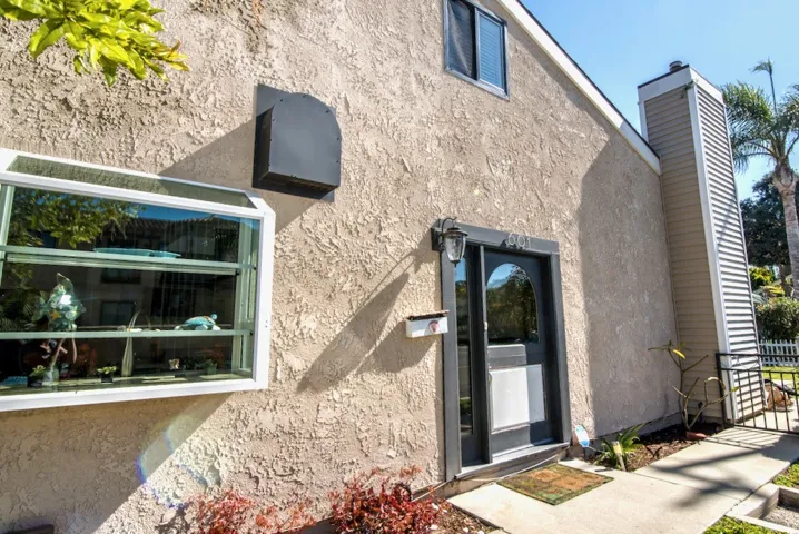 Front Door with kitchen bay window.