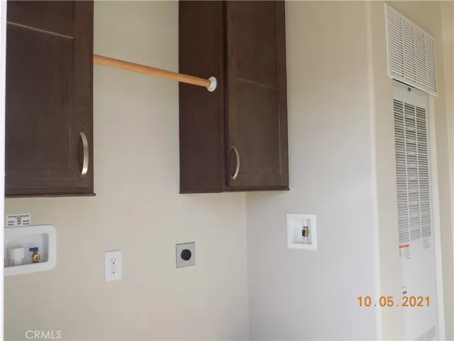 Laundry has all the hookups, clothes bar and cupboards