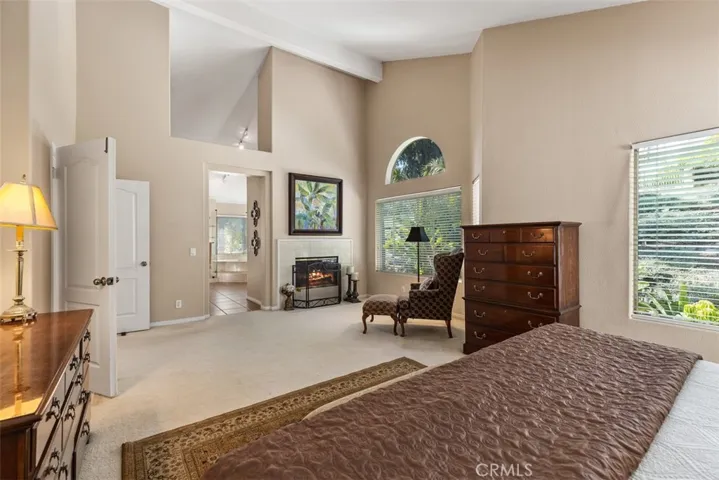 Cozy seating area by the fireplace in the master bedroom