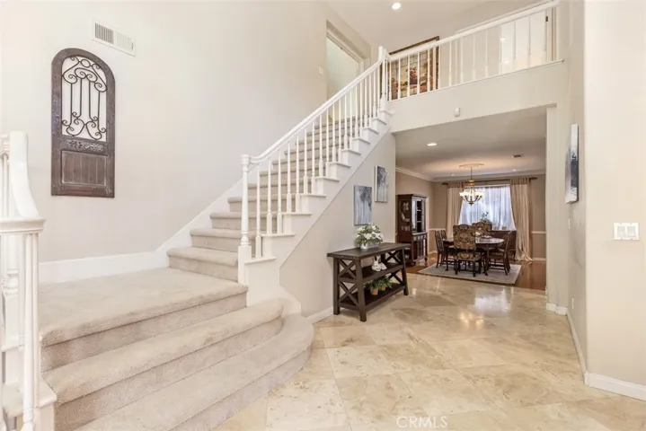 Entry leading to the dining room and leading to the upper level