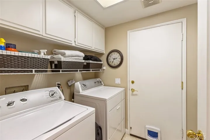 Laundry room with lots of cabinets and a sink