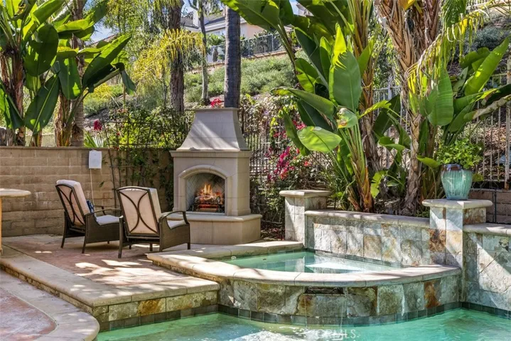 Spa with a custom fireplace to relax after a swim