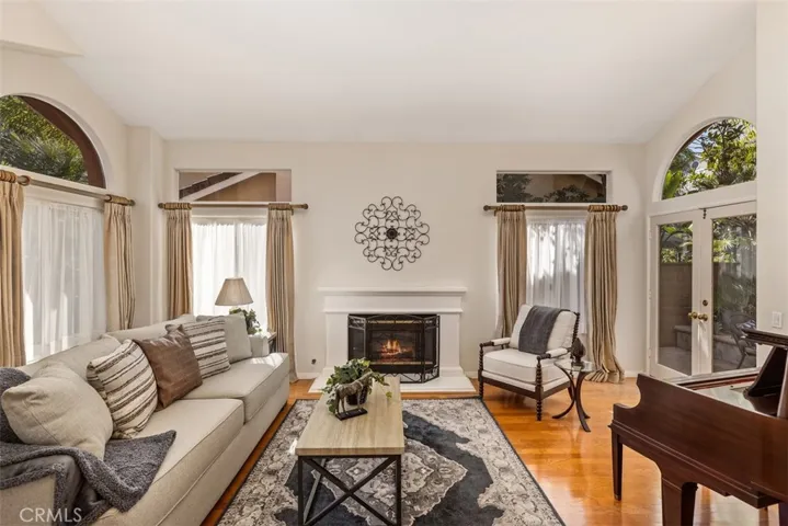 Stunning living room with vaulted ceiling, hardwood floors and a fireplace