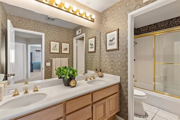 Hall bath is convenient to the bedrooms with separate area for tub/shower and dual sinks