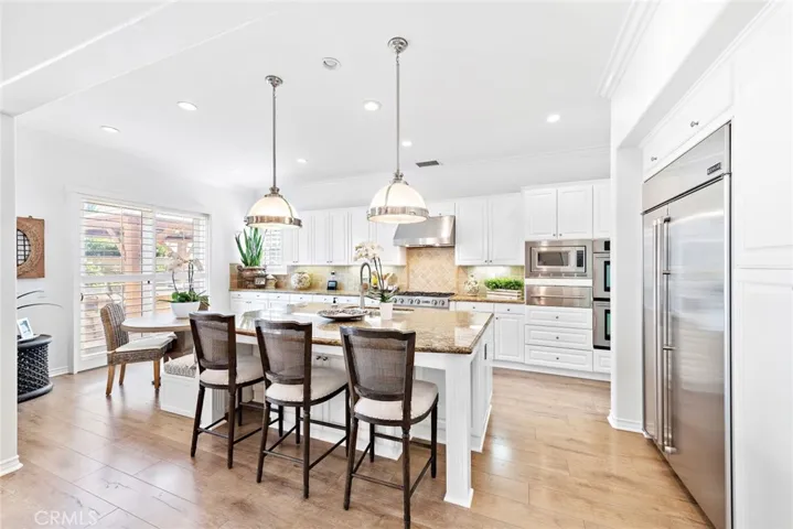 Kitchen has great custom lighting and access to outdoor cooking area