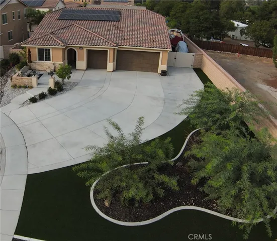 Front Entry: Large Driveway large enough for 8 cars, Turf, Courtyard, Trees.