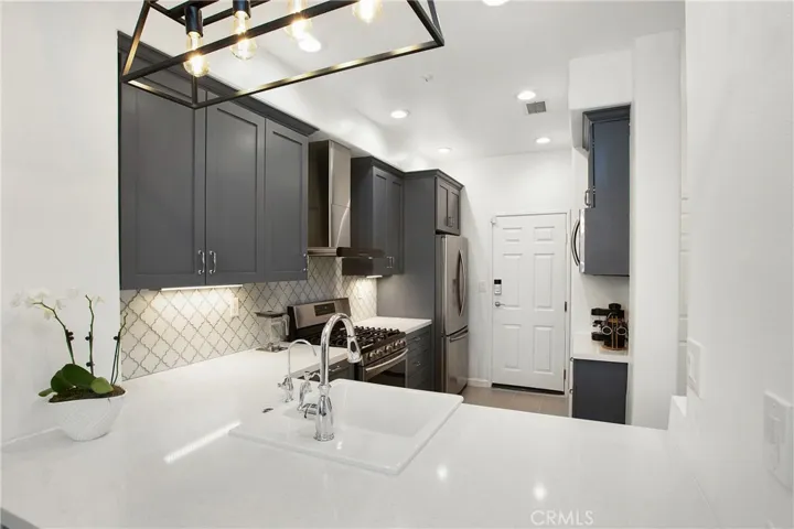 A chef dream with remodeled kitchen with Quartz countertops and glass backsplash