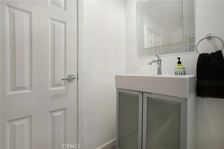 Powder room on main floor with new vanity and extra under stairs closet
