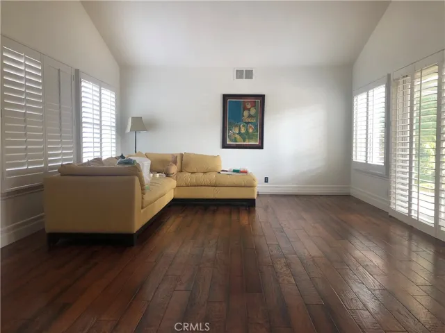 Spacious Living room with high ceilings and outdoor access.