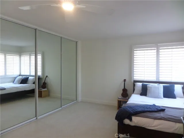 Double wide closet with mirrored door.