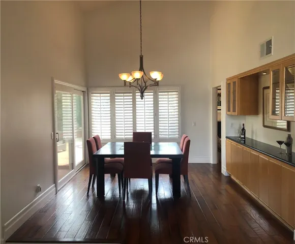 Large dining area with dramatic high ceilings and built-in bar