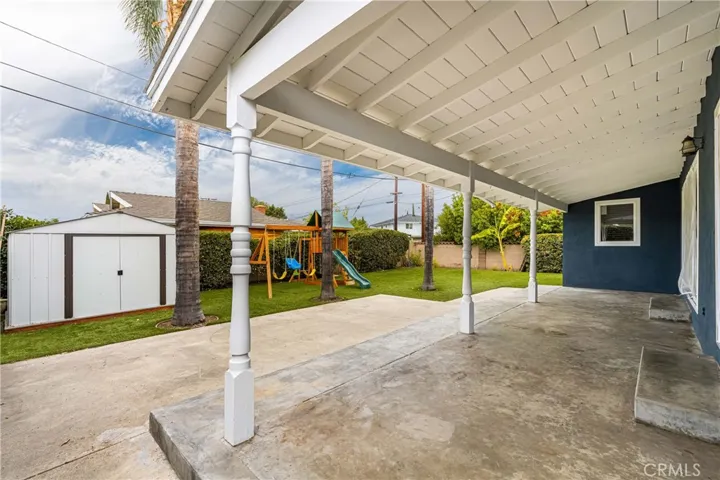 Enjoy this lovely backyard with a covered patio.