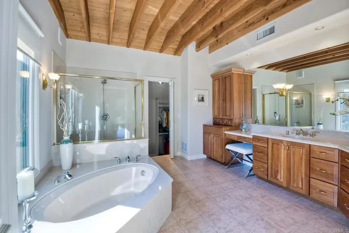Relax in your soaking tub & take in the views! Gorgeous custom wood cabinetry!