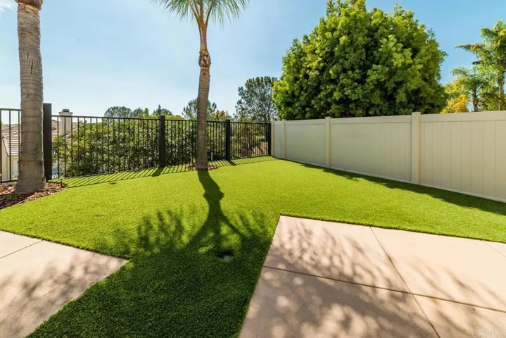 High quality anti-glare Made in USA recyclable turf just installed along with new iron back fence
