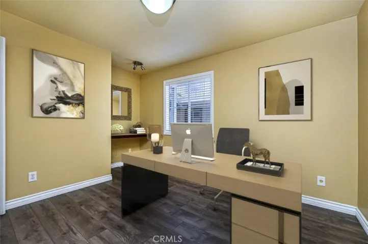 Third bedroom which is just off of the dining room.  It is currently used as an office and is virtually staged in the photo