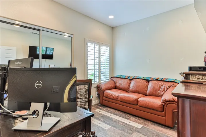 Downstairs bedroom is spacious with recessed lights and mirrored closet door