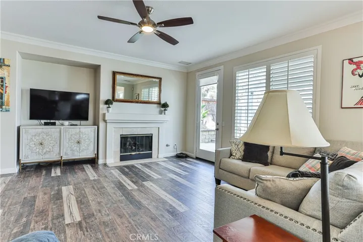 Large family room features crown molding, shutters, and built in speakers