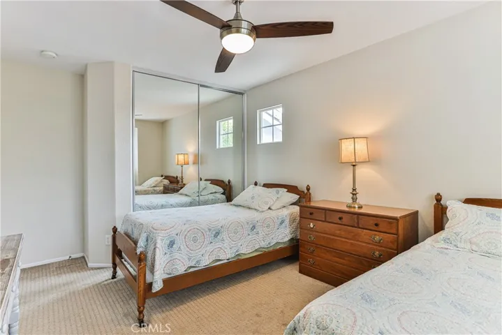 This room also features lighted ceiling fan, mirrored closet doors and shutters.