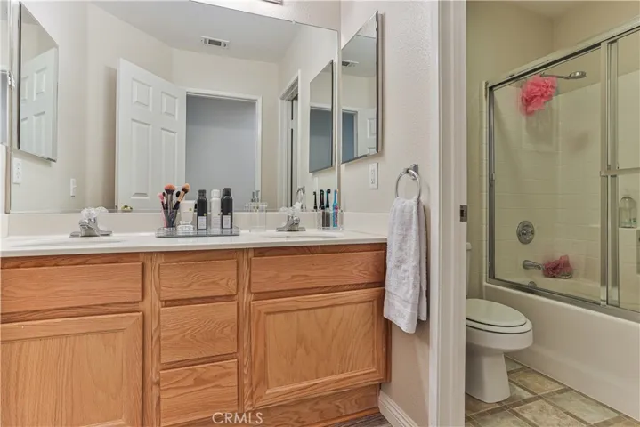 Bathroom #3 has dual sinks and privacy door to the toilet and tub & shower combo.