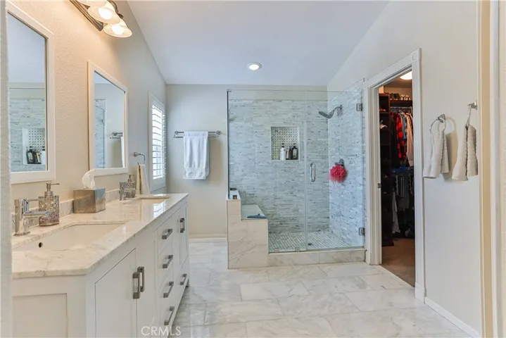 Master bathroom has been updated to include beautiful marble-like counter tops and flooring with dual sinks and a glass enclosed shower