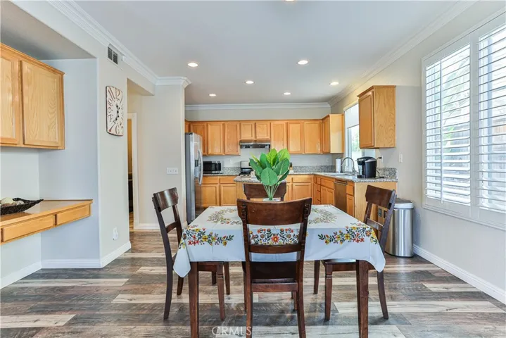 The informal dining area is considerable in size and features cabinets storage and built in desk perfect for billing or homework.