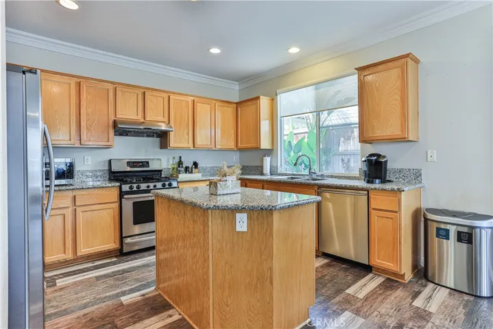 The kitchen in light and bright and offers lots of storage with the recessed lighting and island