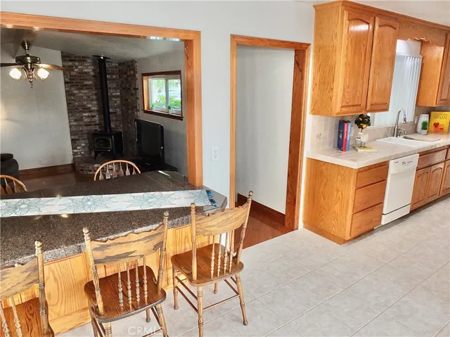 Kitchen to steps leading down to garage-converted family room