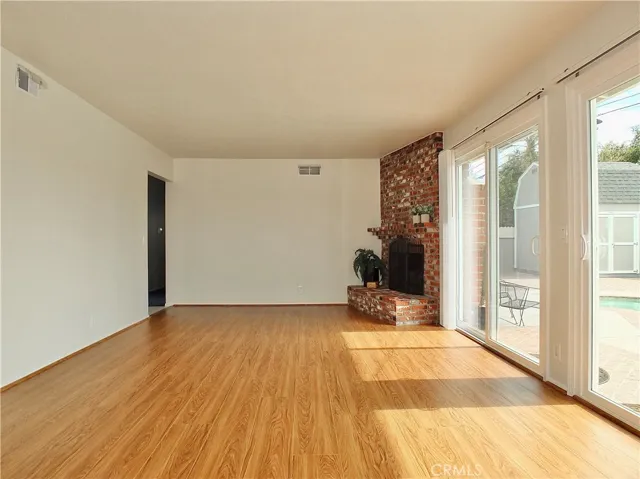 Entrance to living room from front door and leading into back yard/pool through double sliders. Plenty of natural light.