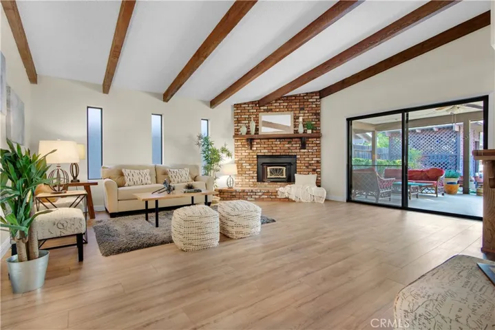 Enjoy entertaining in this large family room with open beam ceilings, new laminate flooring, slider to covered patio area. Most of all enjoy the bricked wood stove on the cold winter nights