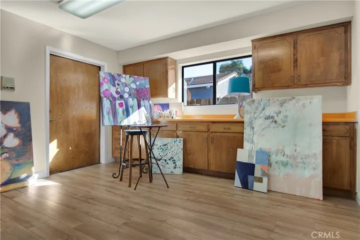 Extra large bonus room perfect as a den, office, craft/sewing room. Features new laminate flooring, lots of storage cabinets and convenient door to the garage