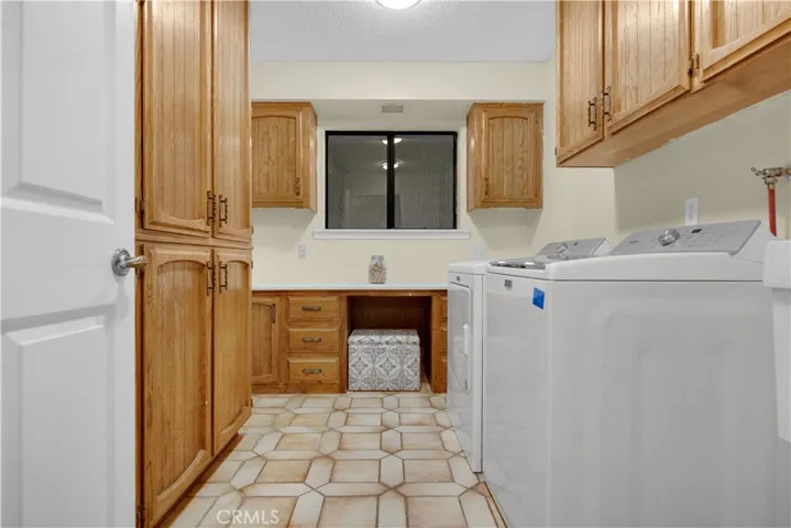 Inside laundry room for your convenience. Plenty of cabinets/storage and a large washtub