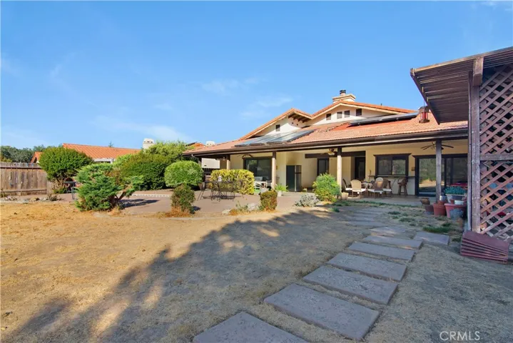 Rear of house features covered patio area, BBQ space and some storage space