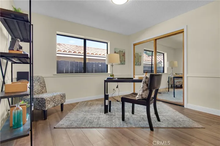 This bedroom has new laminate flooring, mirrored closet doors