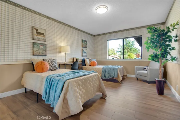 Spacious bedroom with mirrored wardrobe closet doors, new laminate flooring