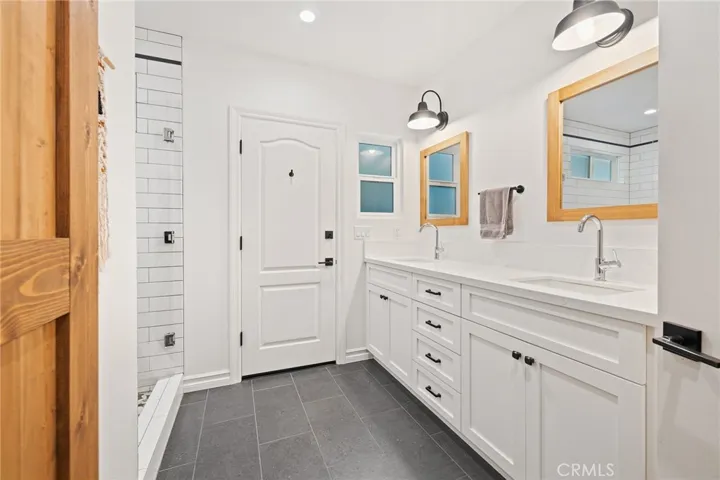 In-law quarters bathroom and storage behind the barn door
