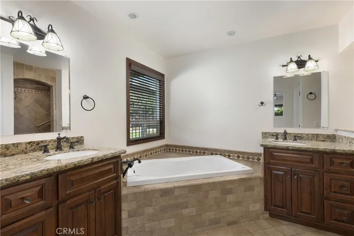 Owner's En-suite, soaking tub, his and her vanity, tile flooring