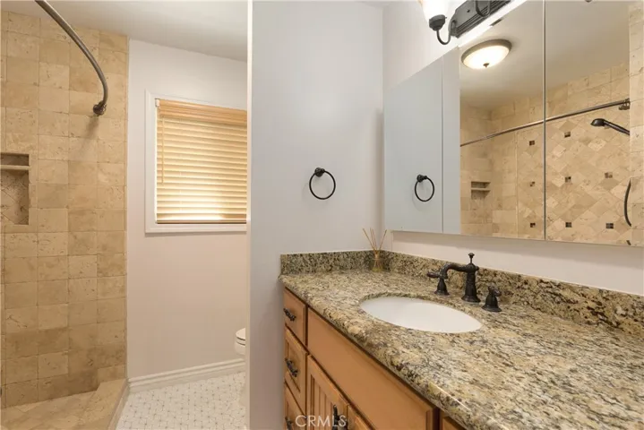 Second bathroom, tiled shower and granite counter vanity
