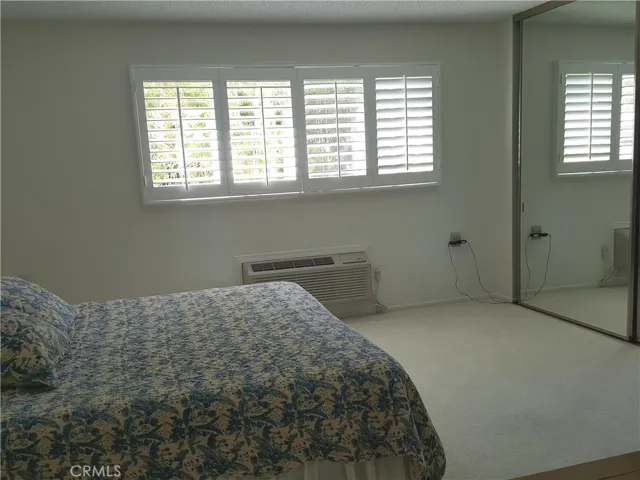 Master bedroom with plantation shutters covered window.