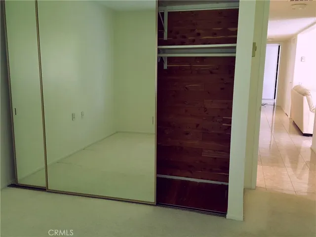 Guest bedroom - mirrored wardrobe with cedar wall.