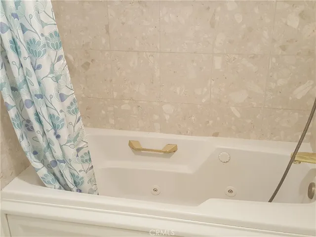 Tile walled-in bath tub with a small window above.