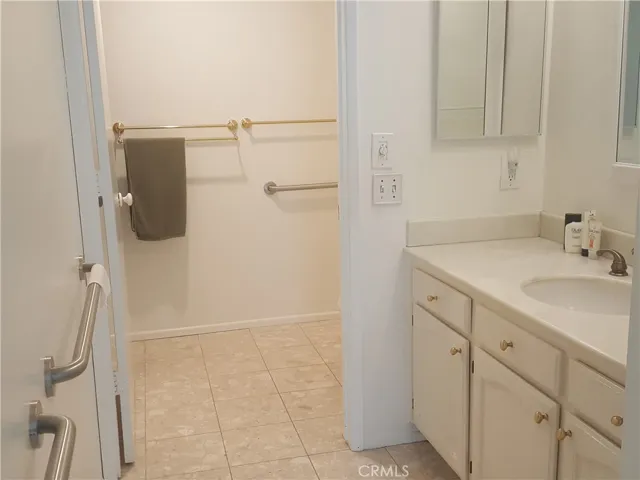 Master bathroom vanity area showing the bath tub and toilet area with separate door.