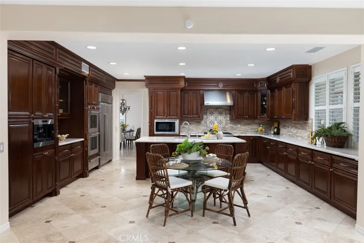 Recently remodeled center island kitchen with WOLF appliacances, furniture quality custom cabinetry, gorgeous quartzite counters, custom backsplash and is open to the family room.